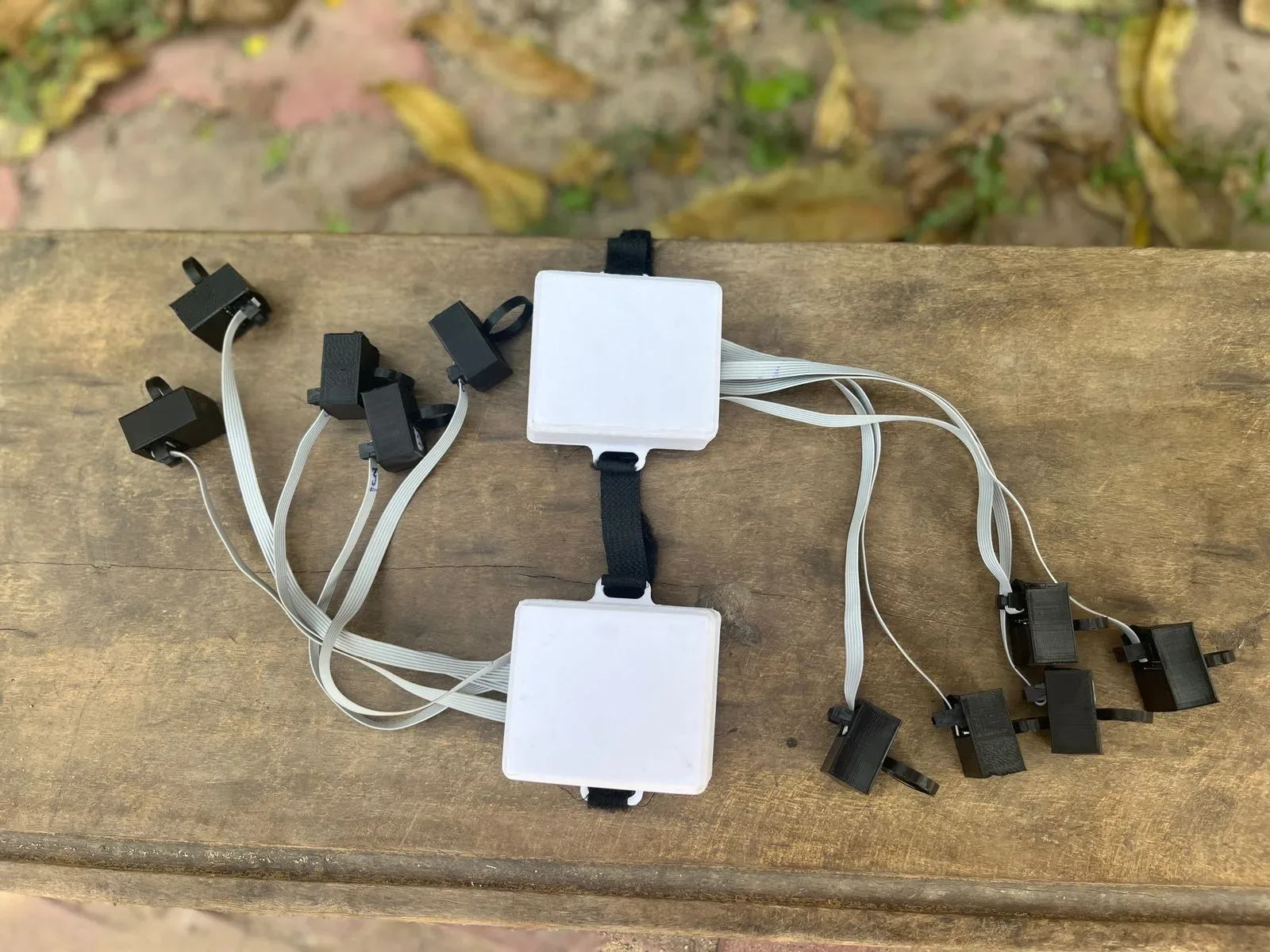 Voicer hardware — wired sensor modules and wrist controller laid out