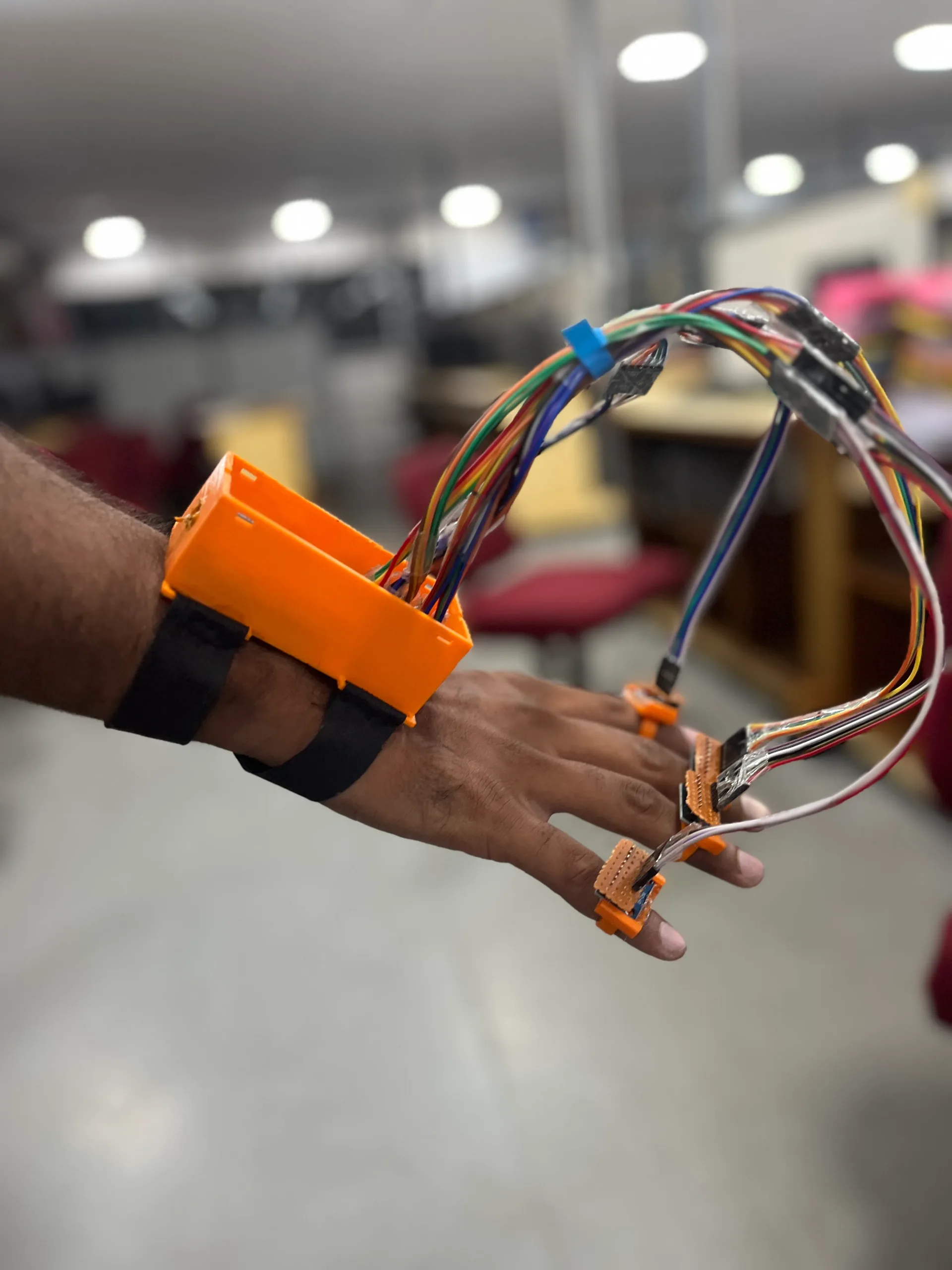 Hand wearing the Voicer device mid-gesture