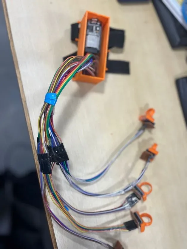 Per-finger IMU wiring of the Voicer glove